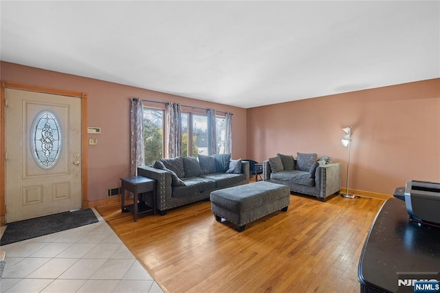 living area featuring visible vents, baseboards, and light wood-type flooring