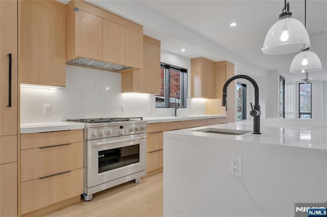 kitchen with high end range, light brown cabinets, modern cabinets, and light stone countertops