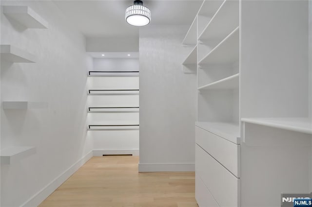 spacious closet with light wood finished floors