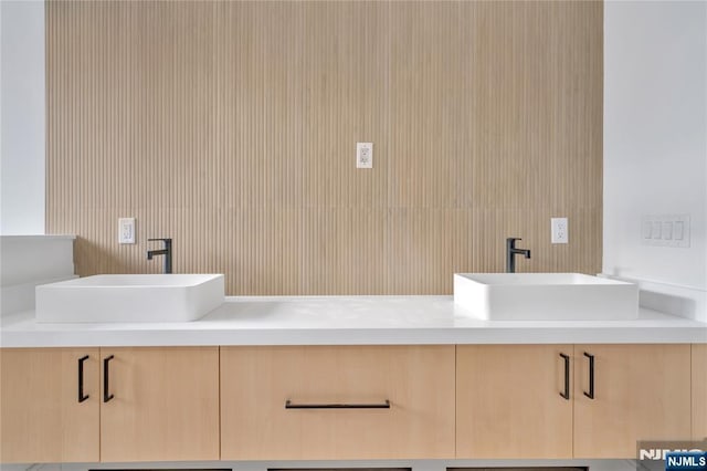 bathroom featuring double vanity and a sink