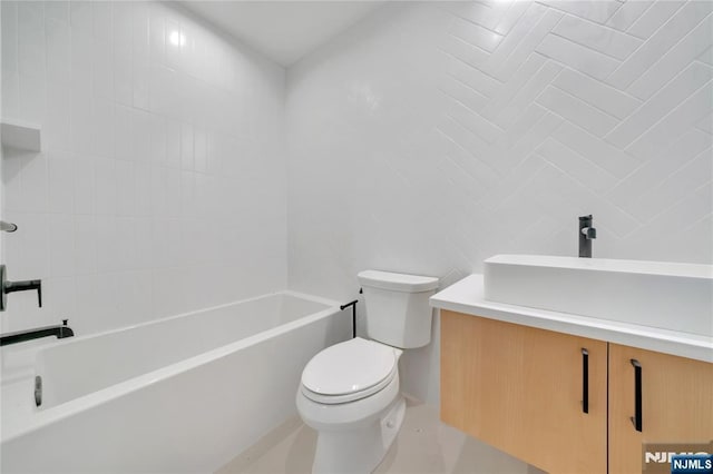 bathroom featuring toilet, tile walls, and vanity