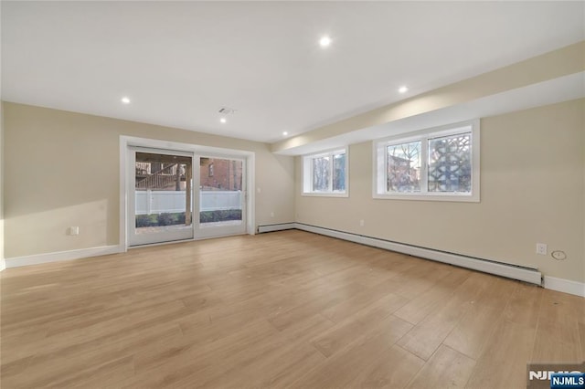 unfurnished room with recessed lighting, a baseboard radiator, baseboards, and light wood finished floors