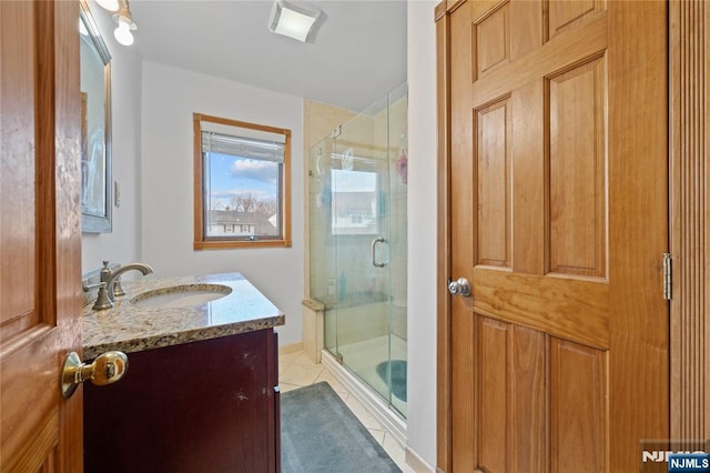 full bathroom featuring vanity, a shower stall, and tile patterned floors