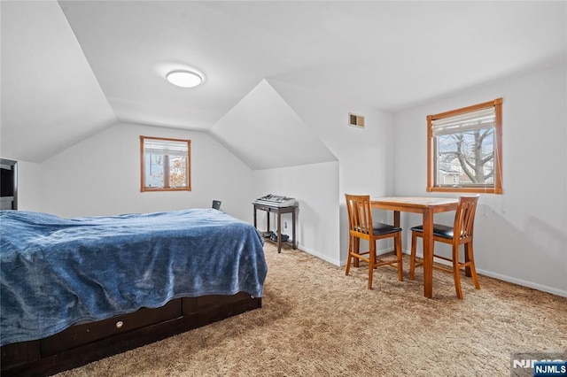 bedroom featuring carpet flooring, visible vents, baseboards, and vaulted ceiling