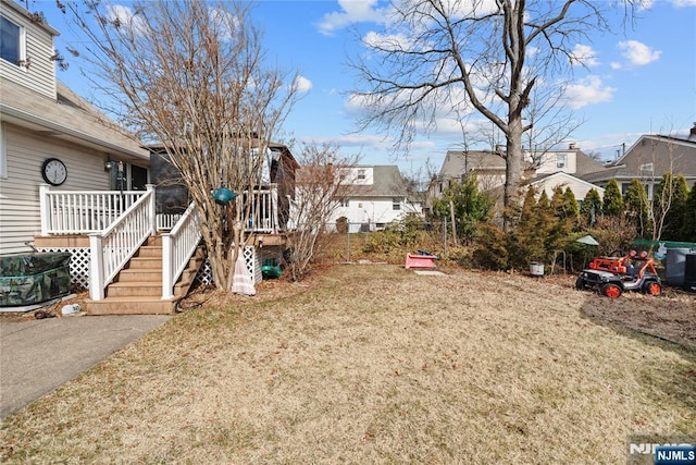 view of yard featuring stairway and a wooden deck