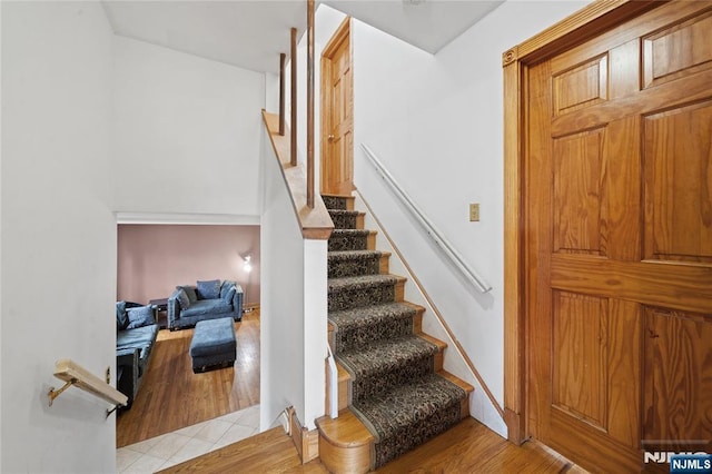 staircase featuring wood finished floors