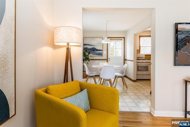 interior space featuring baseboards and light wood finished floors