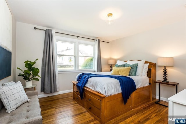 bedroom featuring wood finished floors and baseboards