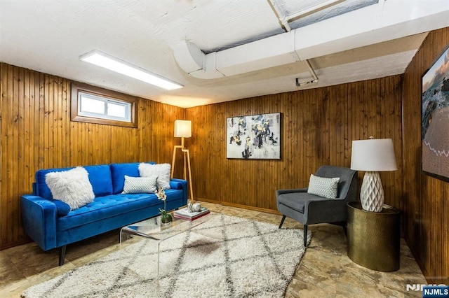 living area featuring wood walls