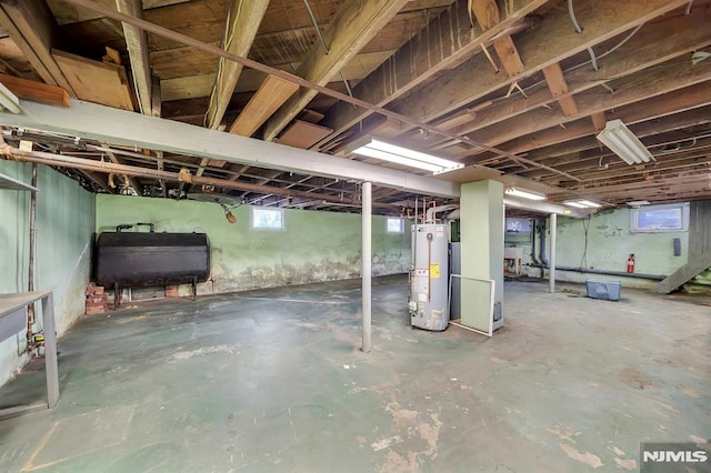 basement featuring heating fuel and water heater