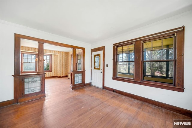 entryway with baseboards, ornamental molding, and hardwood / wood-style flooring