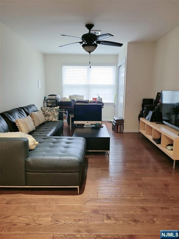 living room featuring a ceiling fan, wood finished floors, and baseboards