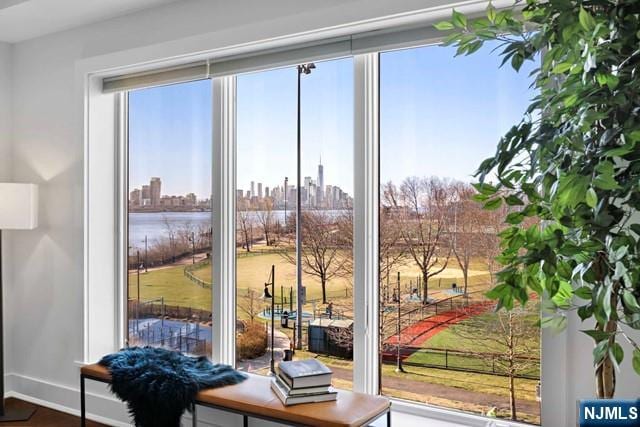 doorway to outside featuring baseboards and a view of city