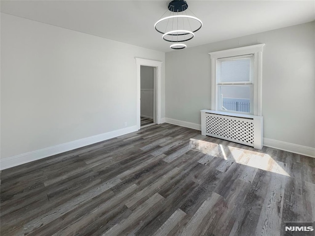 empty room with wood finished floors and baseboards