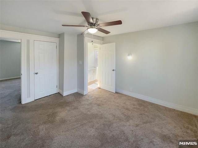 unfurnished bedroom with baseboards, carpet, and ceiling fan