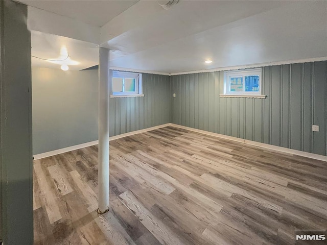 below grade area with wood finished floors and baseboards