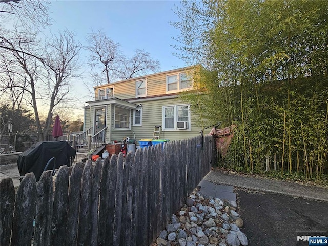 rear view of property featuring a fenced front yard