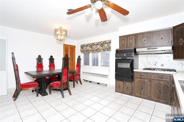 dining room featuring ceiling fan with notable chandelier and radiator heating unit