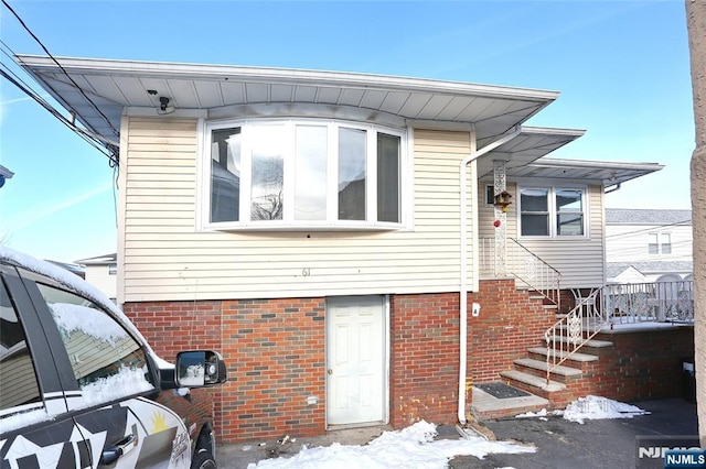 view of front of home featuring brick siding