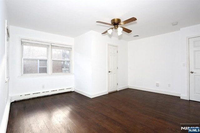 spare room featuring wood finished floors, baseboards, visible vents, a baseboard radiator, and ceiling fan