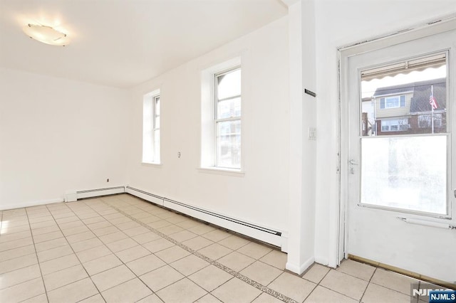 unfurnished room featuring light tile patterned floors, baseboards, and baseboard heating