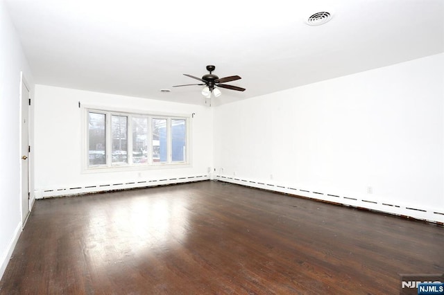 empty room featuring a baseboard heating unit, wood finished floors, visible vents, and a ceiling fan