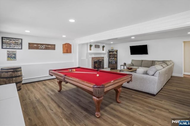 rec room with a baseboard heating unit, wood finished floors, recessed lighting, pool table, and a brick fireplace