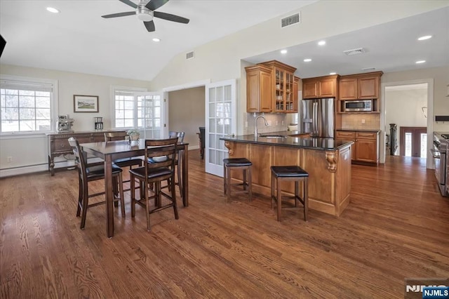 dining area featuring visible vents, dark wood finished floors, ceiling fan, vaulted ceiling, and french doors