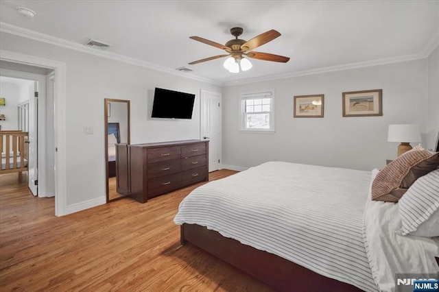 bedroom featuring crown molding, light wood-style flooring, baseboards, and visible vents