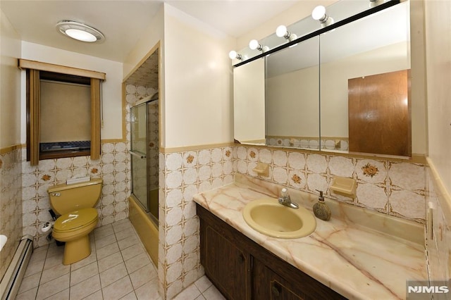 full bathroom with a wainscoted wall, toilet, a baseboard heating unit, tile patterned flooring, and vanity