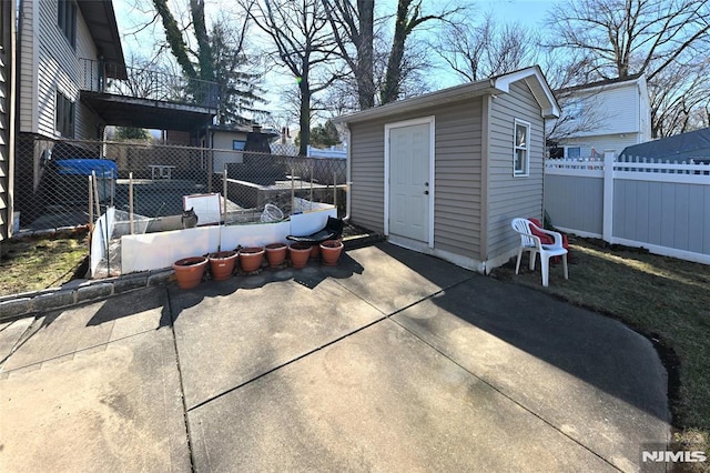 view of patio with a fenced backyard and an outdoor structure