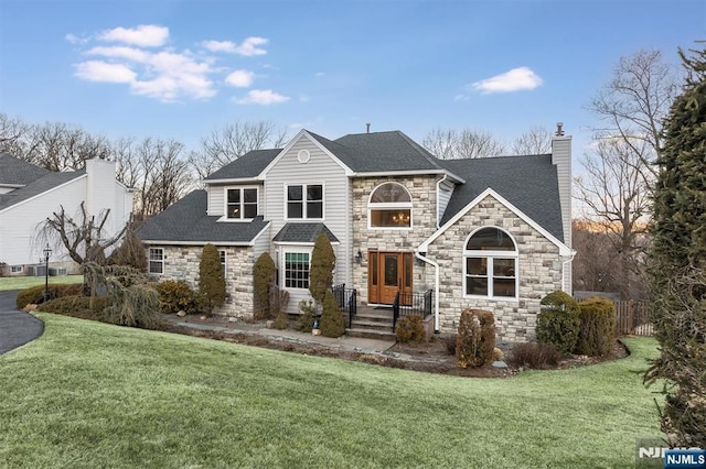 view of front of property featuring a front yard, fence, roof with shingles, and a chimney