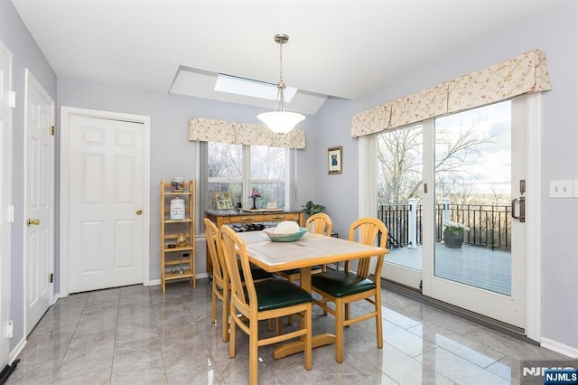 dining area featuring baseboards