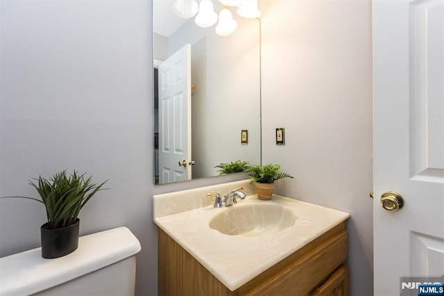 half bathroom featuring toilet and vanity