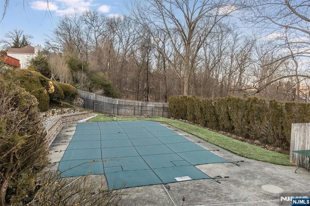 view of pool featuring a patio, fence, and a fenced in pool