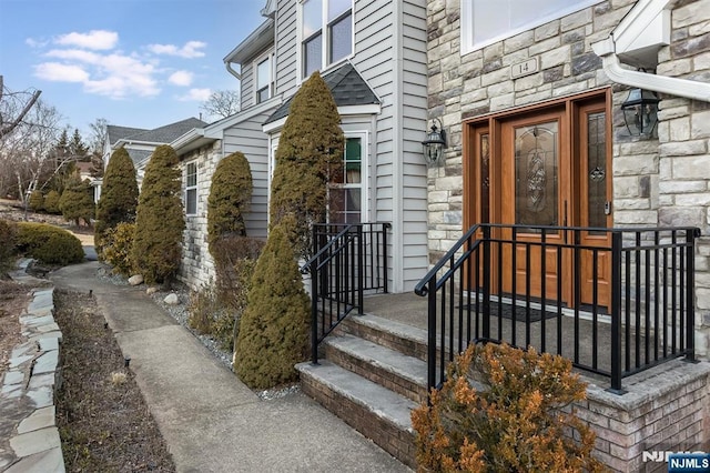 property entrance with stone siding