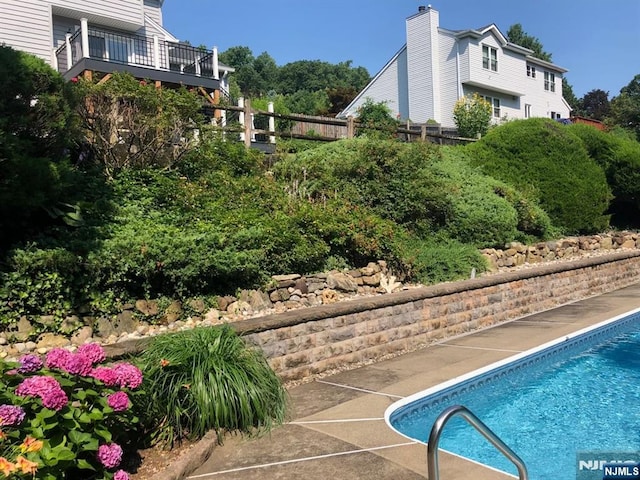 view of swimming pool featuring a fenced in pool and fence