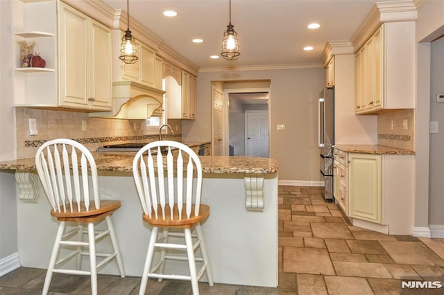 kitchen with high end fridge, a peninsula, baseboards, and light stone countertops