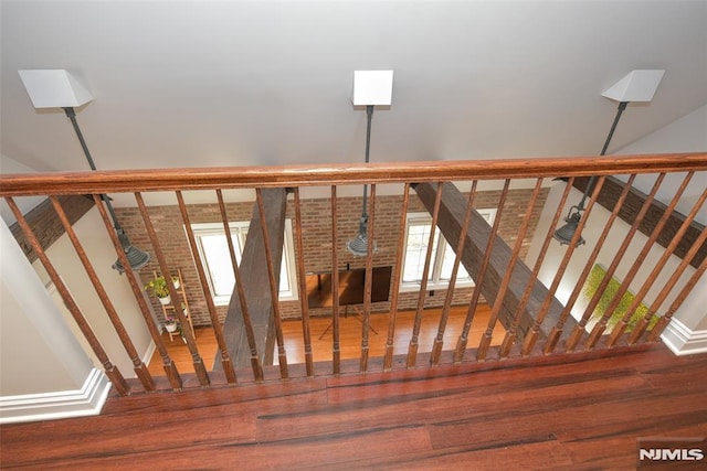 stairs featuring wood finished floors