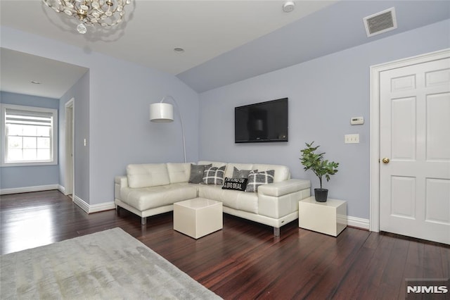 living area with visible vents, baseboards, and wood finished floors