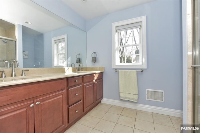 full bathroom featuring a sink, visible vents, a stall shower, and a wealth of natural light