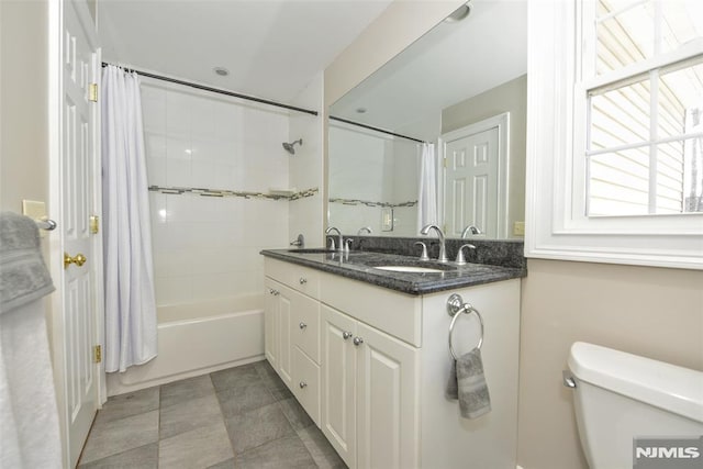 full bath featuring toilet, vanity, and shower / bath combination with curtain