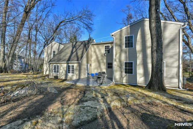 rear view of property featuring a patio area