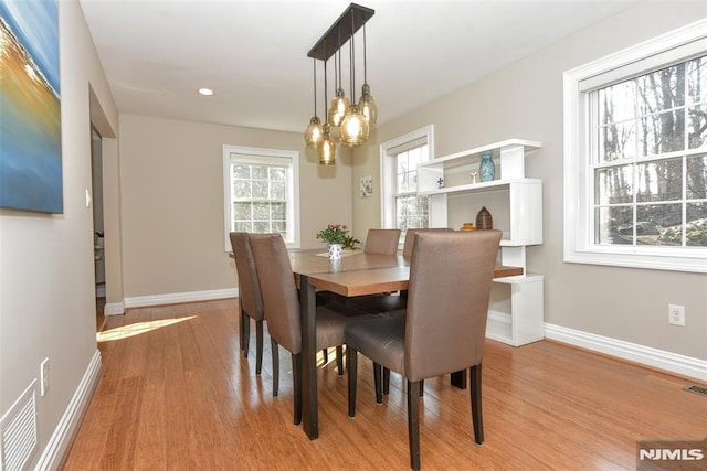 dining room with visible vents, baseboards, recessed lighting, light wood-style floors, and a chandelier