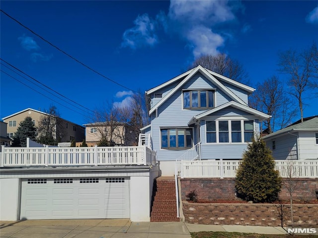 view of front of home with stairway, driveway, and a garage