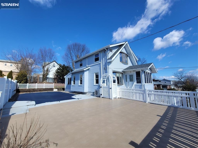 exterior space with fence and a sunroom