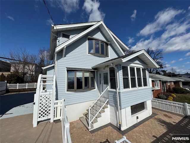 view of front of house with a sunroom