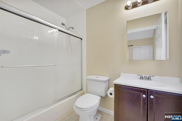 full bath with tile patterned floors, toilet, vanity, and shower / bath combination with glass door