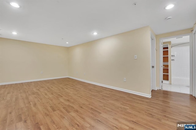 unfurnished room with recessed lighting, baseboards, and light wood-style flooring