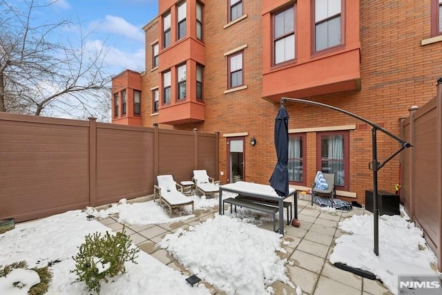 snow covered patio with fence